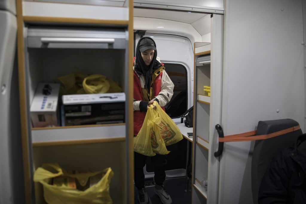 Misha is an outreach worker who works with people who inject drugs. He is gathering supplies in their mobile clinic for the community.