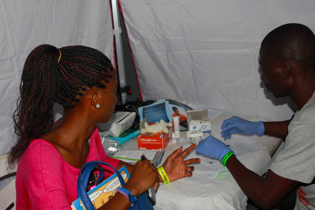 Young women getting tested for HIV at a healthcare facility in Africa.