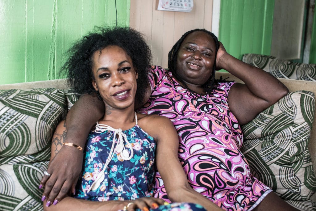 Transgender couple Lorraine and Quincy sitting next to each other in an embrace. Quincy is the Founder of Guyana Trans United.