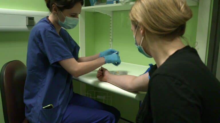 Nurse conducts an HIV test at a London hospital as part of the world's first-ever HIV Social Impact Bond.