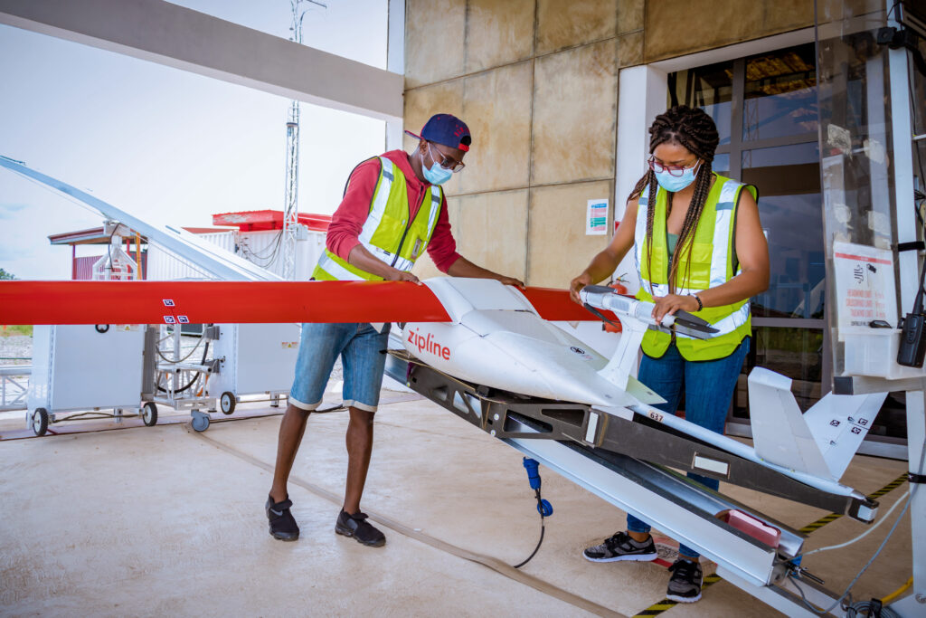 Zipline team members preparing a drone to deliver life-saving HIV treatment to communities that live in rural areas.