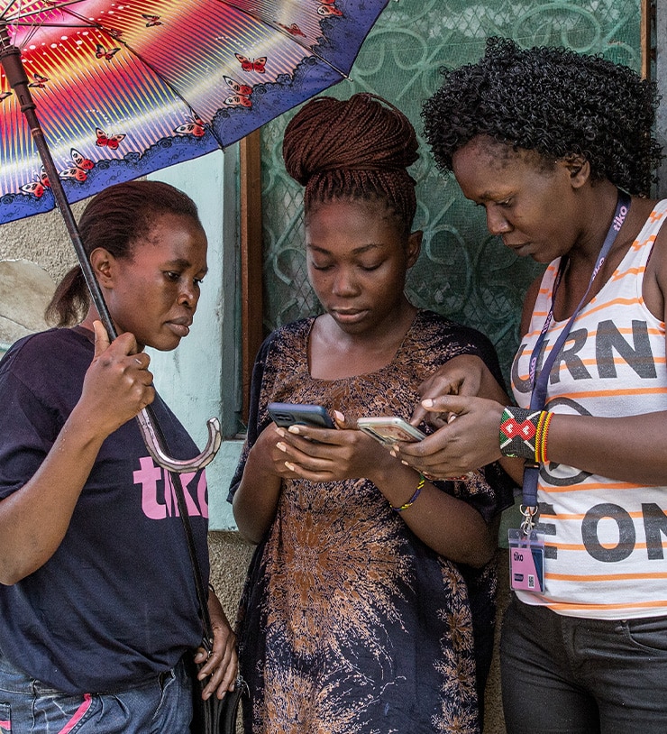Triggerise 'Tiko' Mobilizers engaging with young person in Kenya and showing how the Tiko app can support their sexual health and mental health needs.