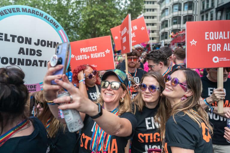 Elton John AIDS Foundation team members smile for photos at London Pride