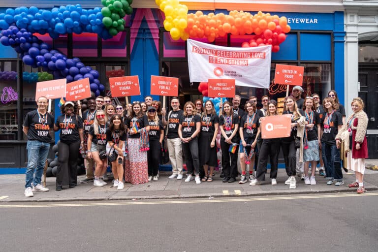 The Elton John AIDS Foundation team at London Pride, holding placards and banners.