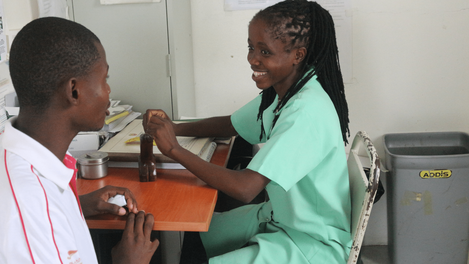 Duarte, a young person living with HIV who has been supported through partners of the Elton John AIDS Foundation, sits speaking to a friendly peer counsellor.