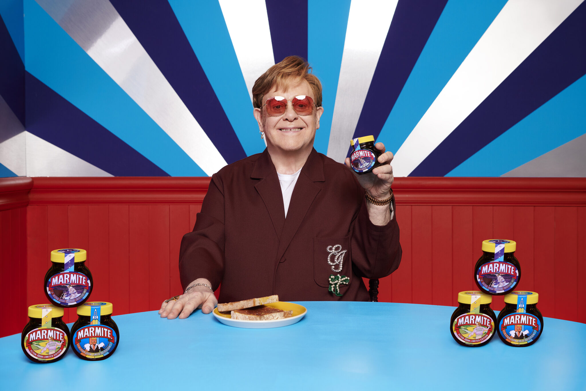 Elton John holds up limited edition jar of Marmite.