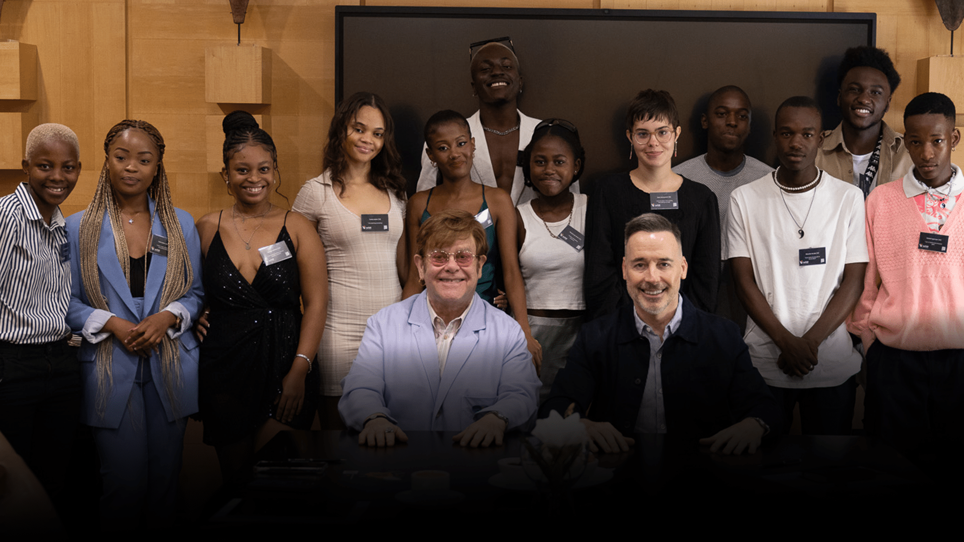Elton John and David Furnish with a group of young people in South Africa.